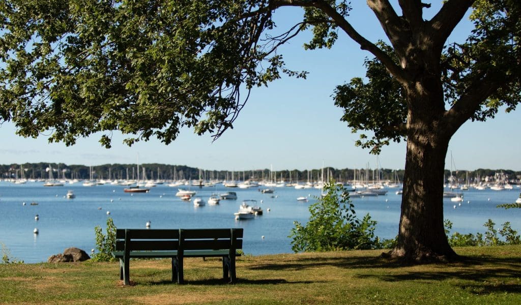 Empty Park Bench Overlooking the Water at The Salem Garden in Winter Island in Salem MA