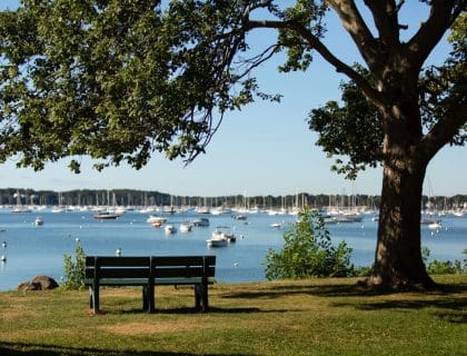 Empty Park Bench Overlooking the Water at The Salem Garden in Winter Island in Salem MA