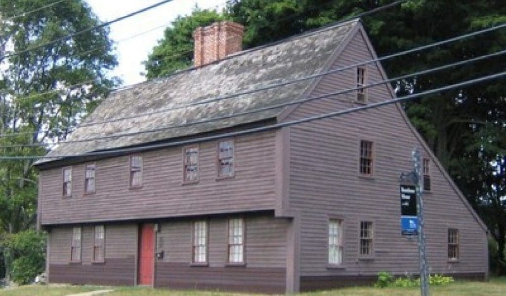 View of the brown exterior and red entrance door of The Boardman House in Saugus MA