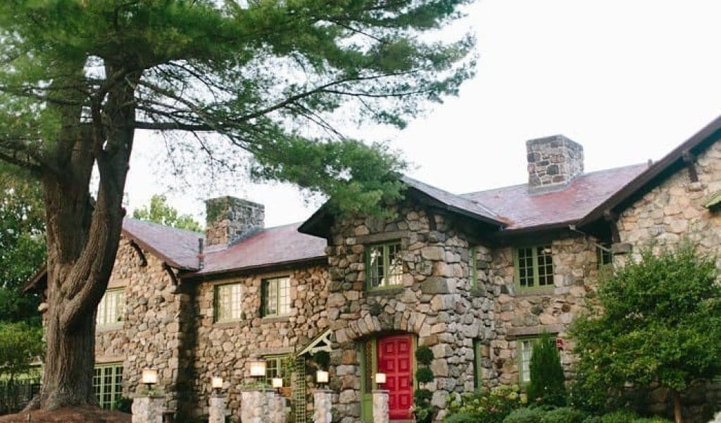 View of the exterior of the Willowdale Estate in Topsfield MA with a large tree to the front left side