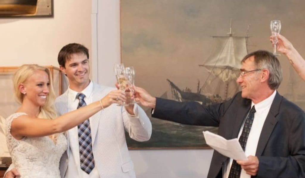 Bride and groom toasting in a gallery