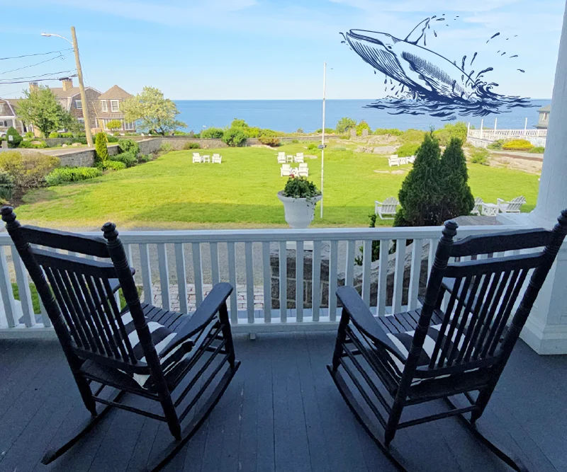 Two rocking chairs on a porch overlooking the ocean